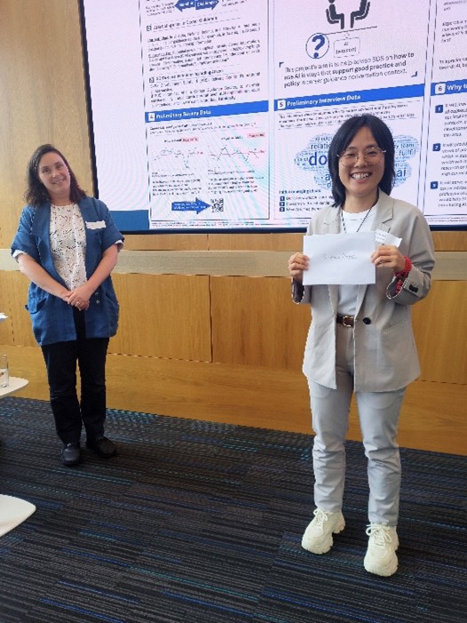 Ruimei Jiang holding her prize certificate in front of her research poster